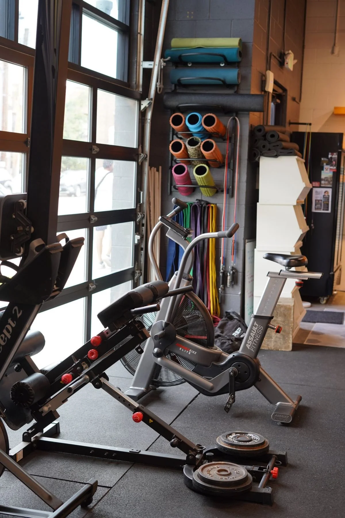 Rower, assault bike and mobility tools by the garage door