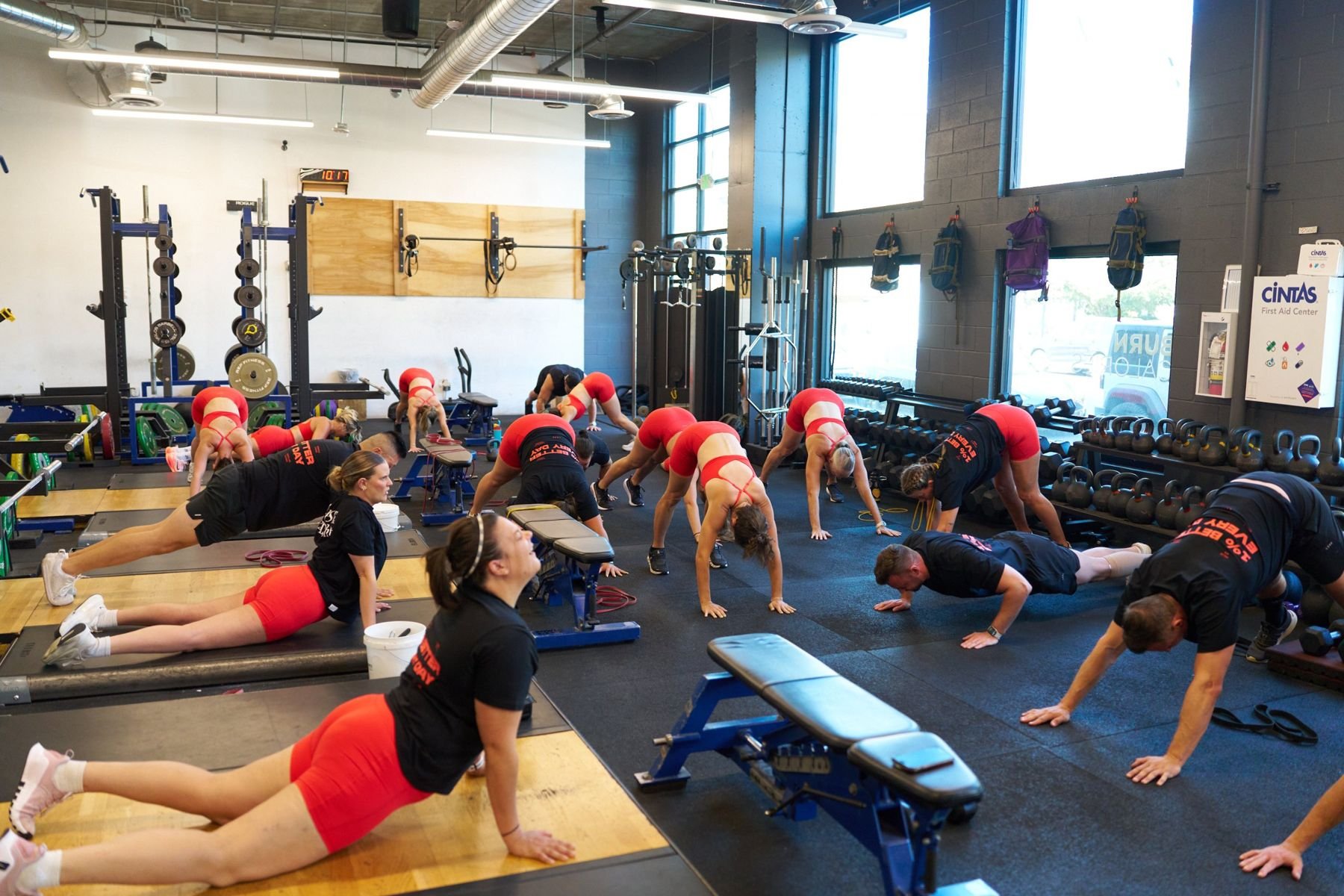 A full Small Group Training session warming up on the gym floor