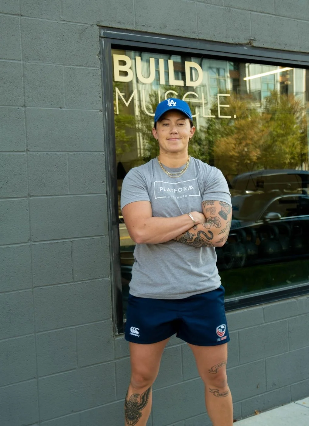 Coach Sav in a Platform Strength shirt outside the gym