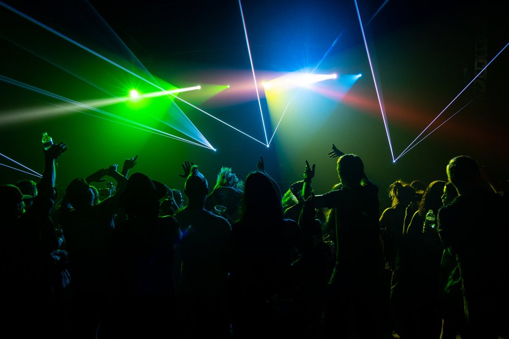Lasers sweeping over the crowd at a live show