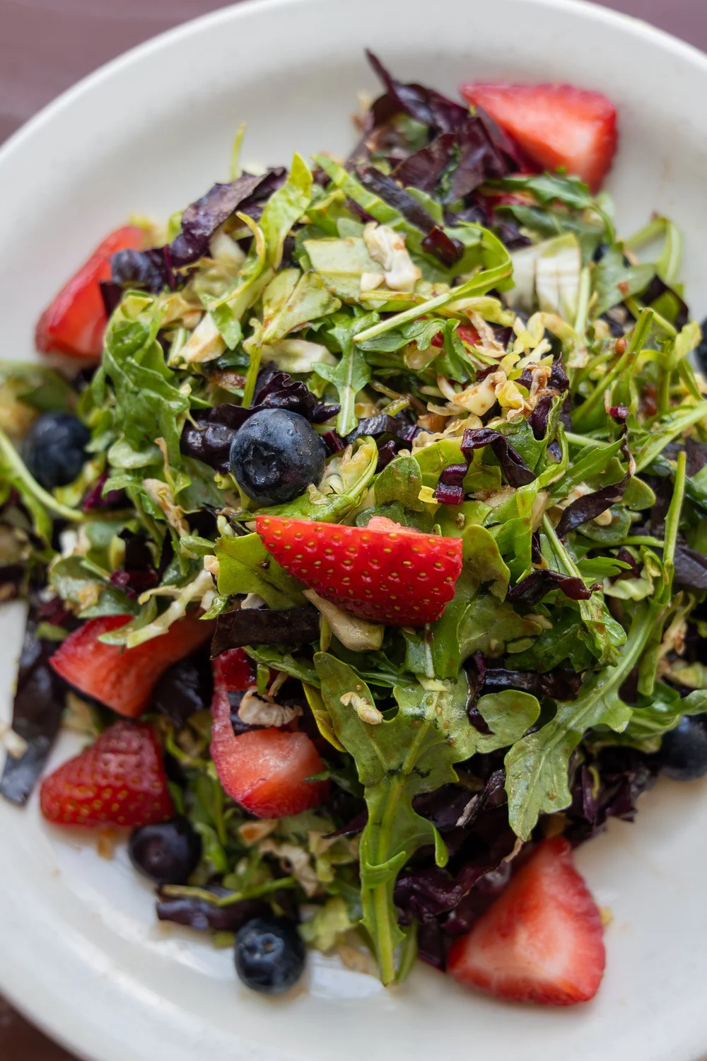 Berry and arugula salad with strawberries and blueberries plated at a Chattanooga restaurant