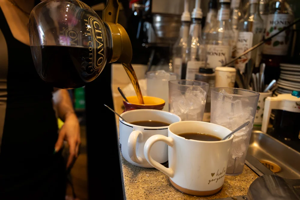 Coffee being poured behind the counter at a Chattanooga cafe