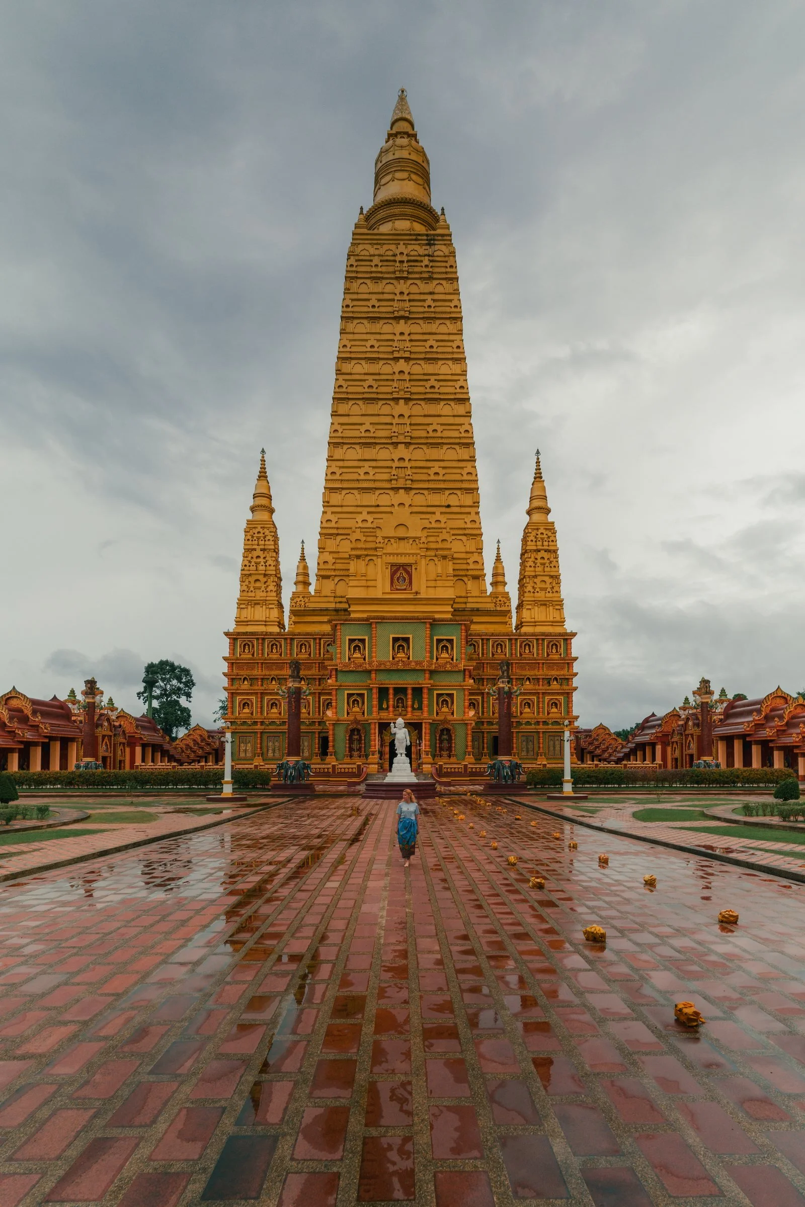 Traveller at an ornate golden temple in Thailand