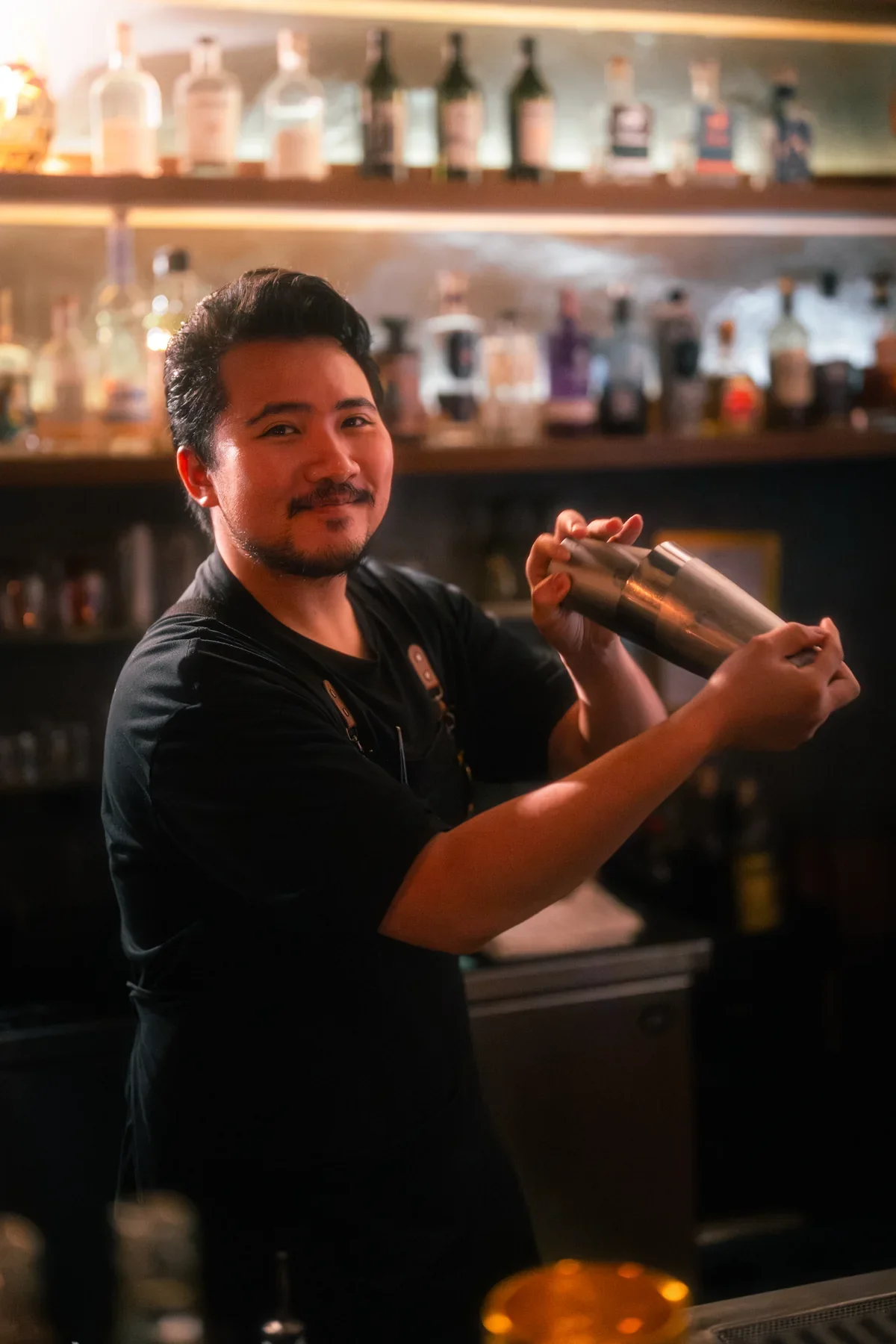 Portrait of a TEP BAR bartender with a cocktail shaker
