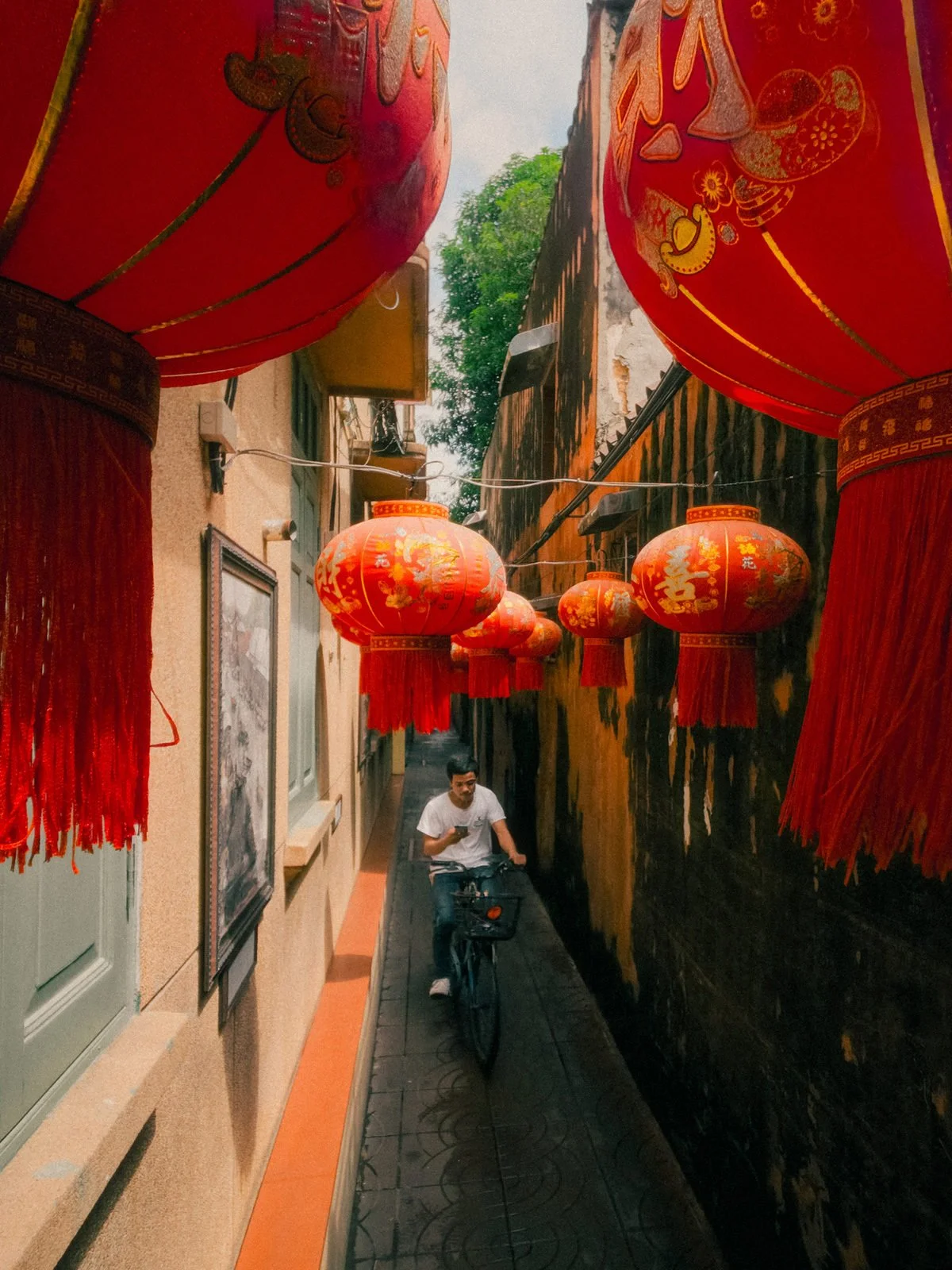 Red lanterns above a narrow Bangkok alley