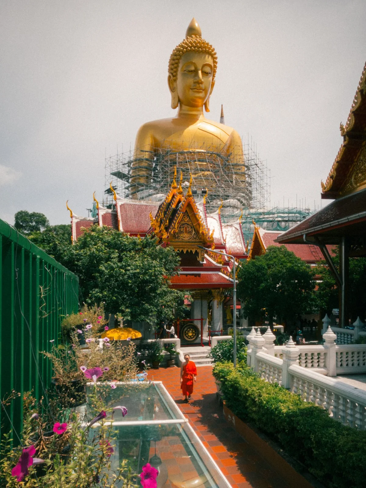 Buddha statue rising above a Bangkok temple garden