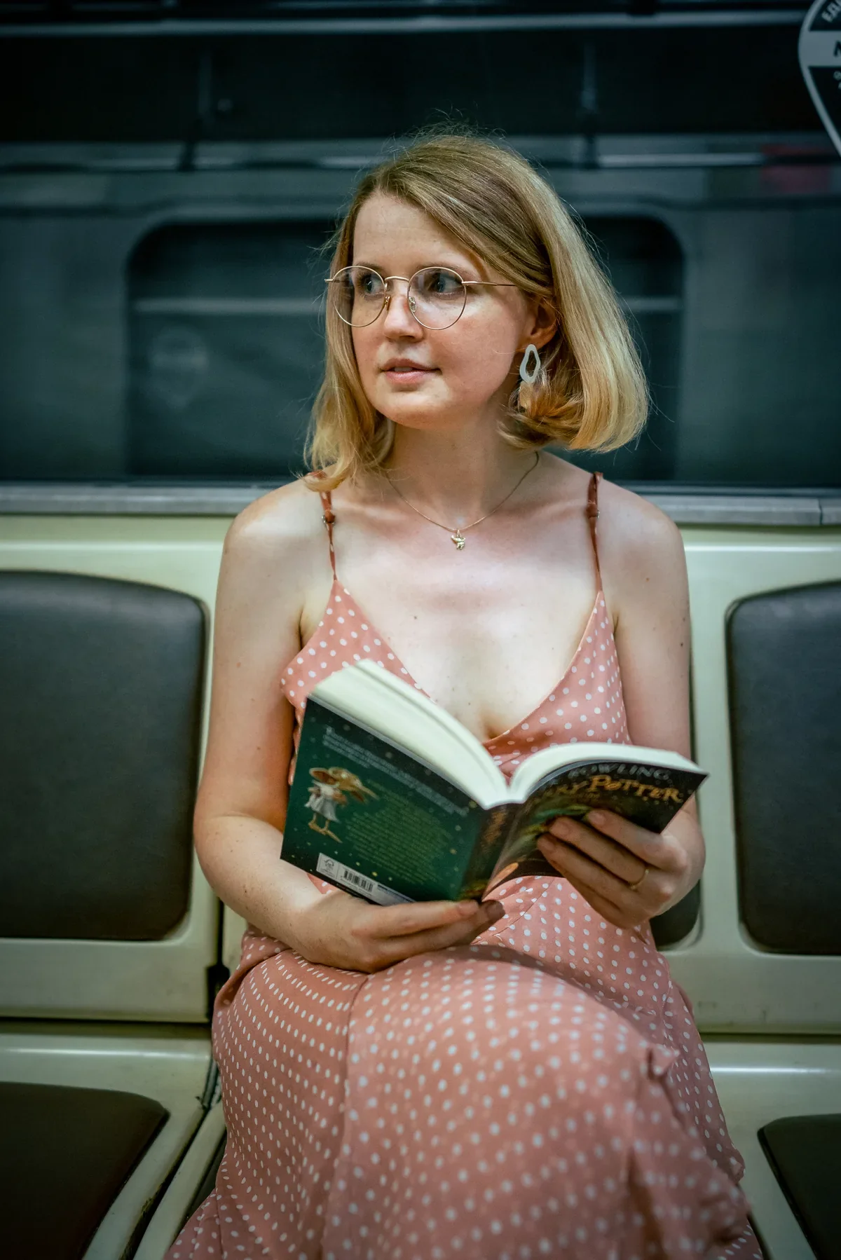 Woman wearing TIJN glasses while reading on the metro