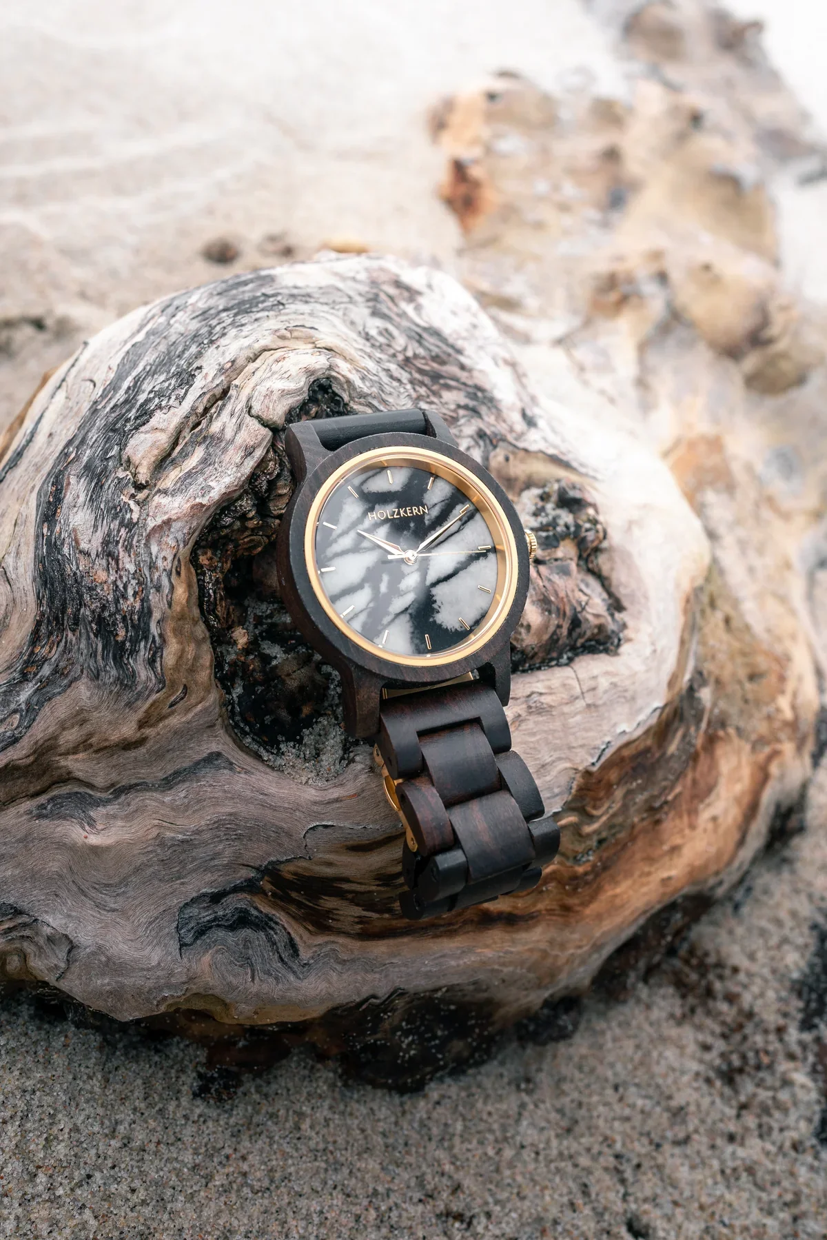 Dark Holzkern watch framed by the grain of pale weathered wood
