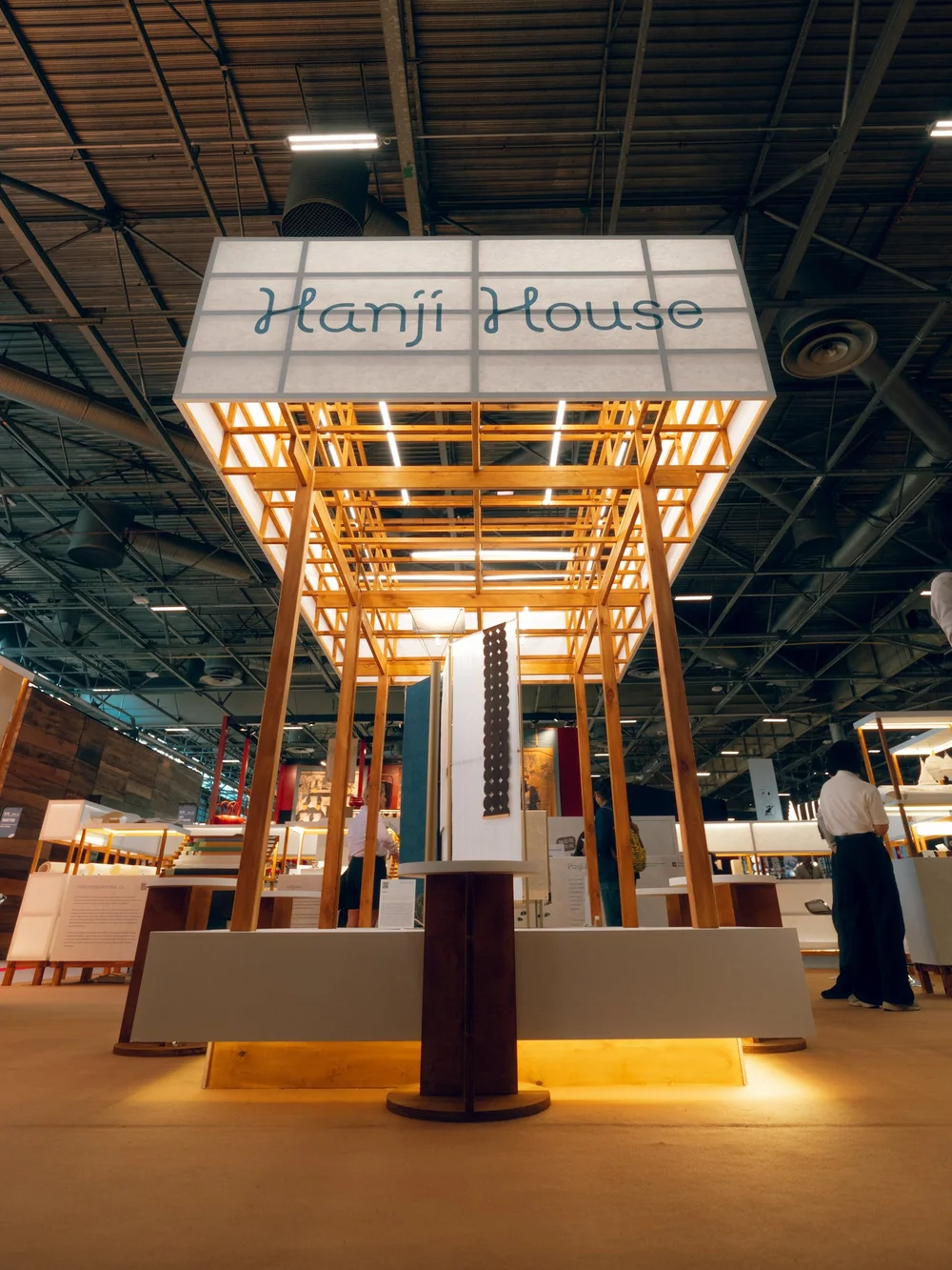 Hanji House sign above the timber pavilion and suspended paper displays