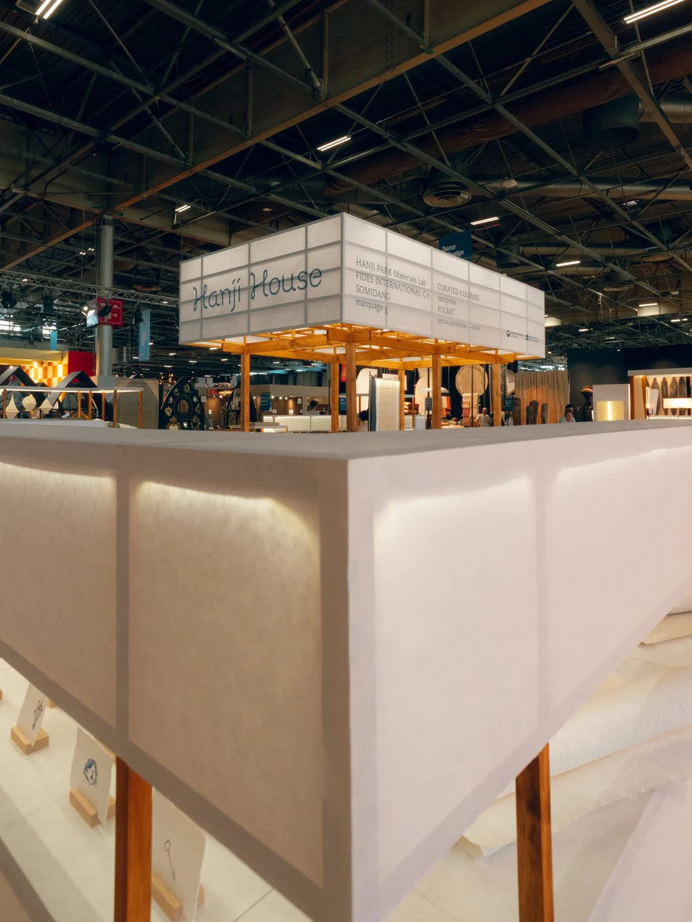 Glowing paper screens framing the HANJI HOUSE pavilion at Maison et Objet