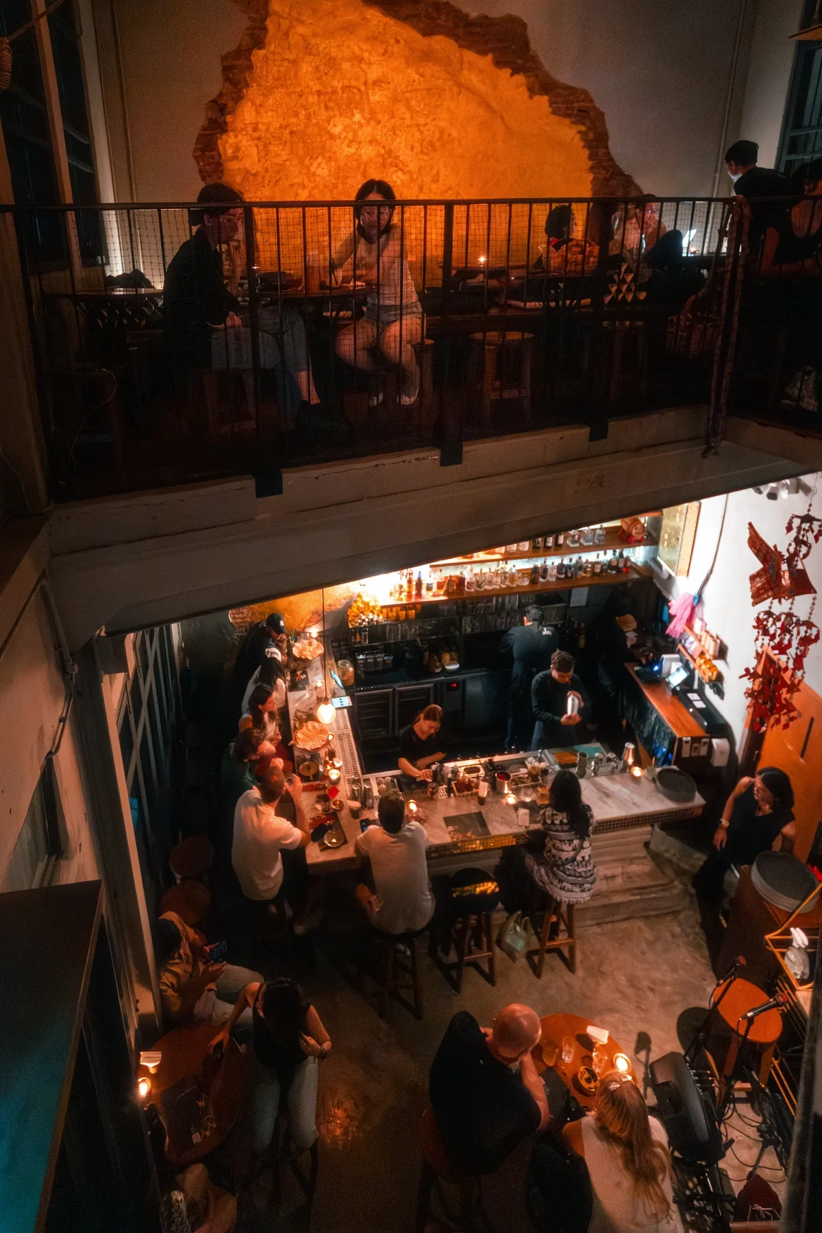 Two levels of guests gathered around the bar