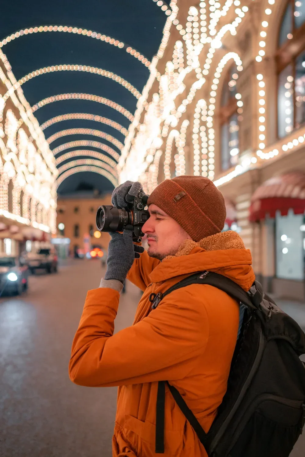 Photographer working beneath an illuminated arcade