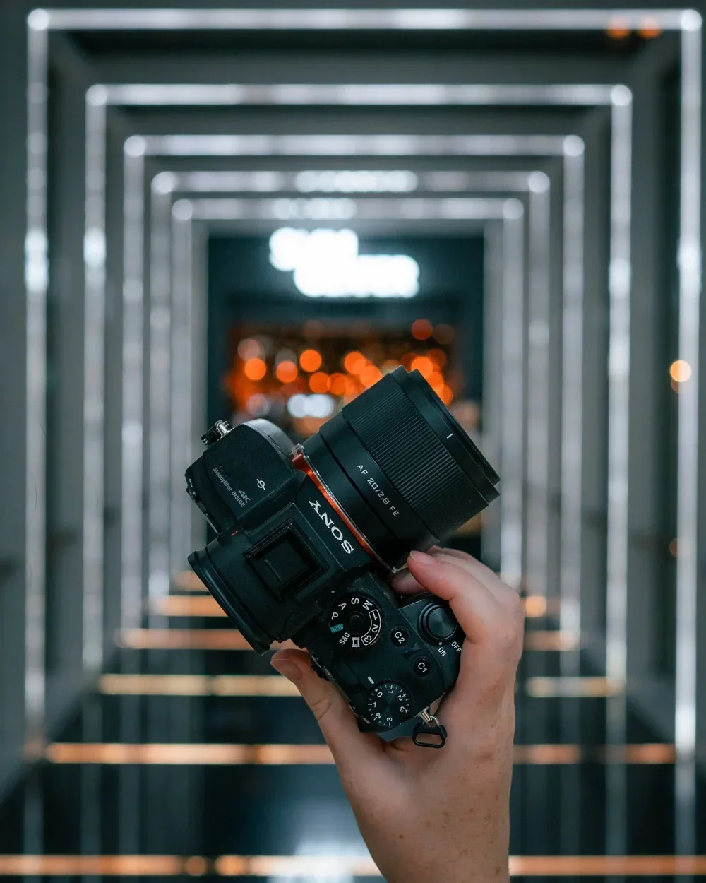 Viltrox lens mounted on a camera inside a modern corridor