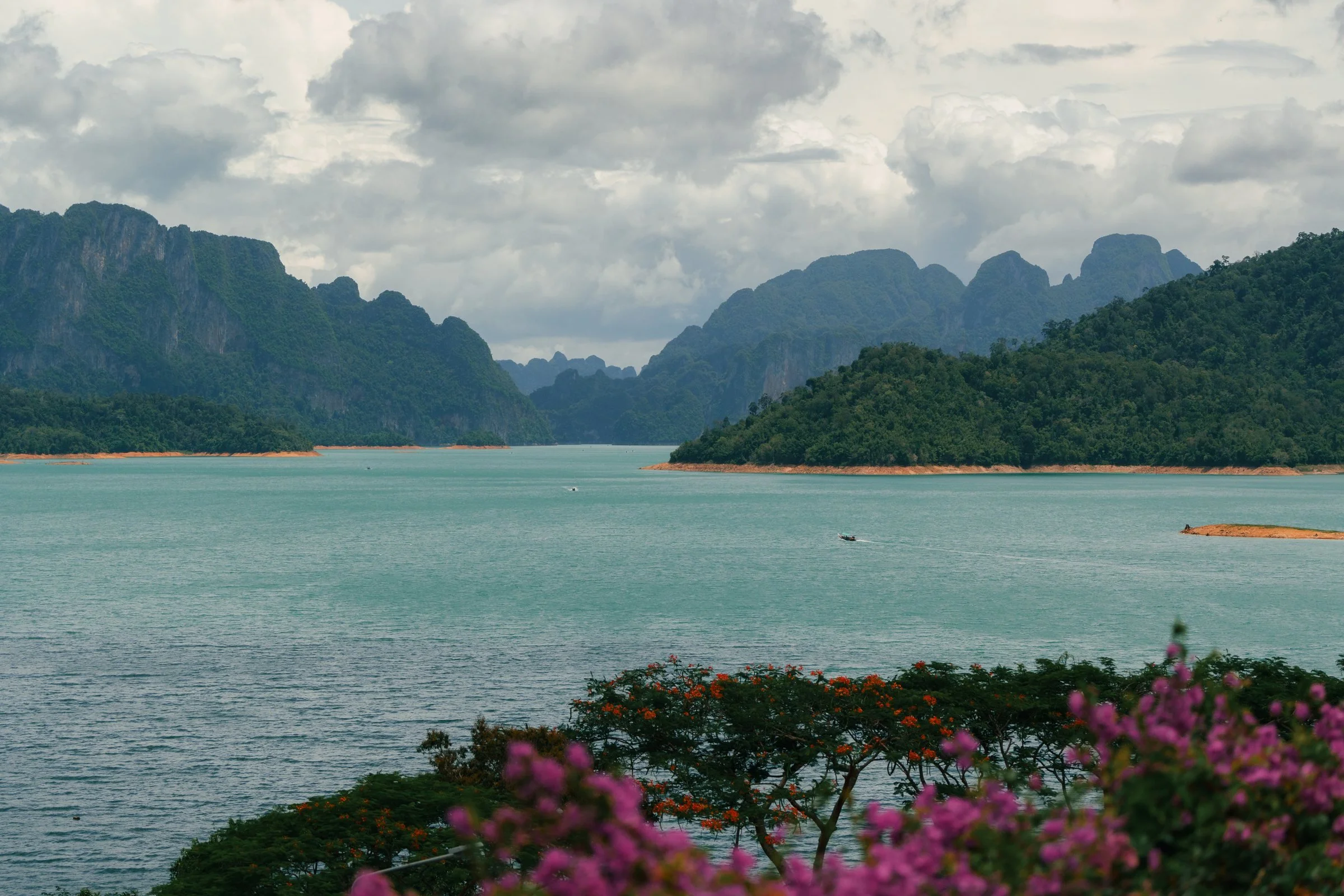 Turquoise lake surrounded by green limestone mountains