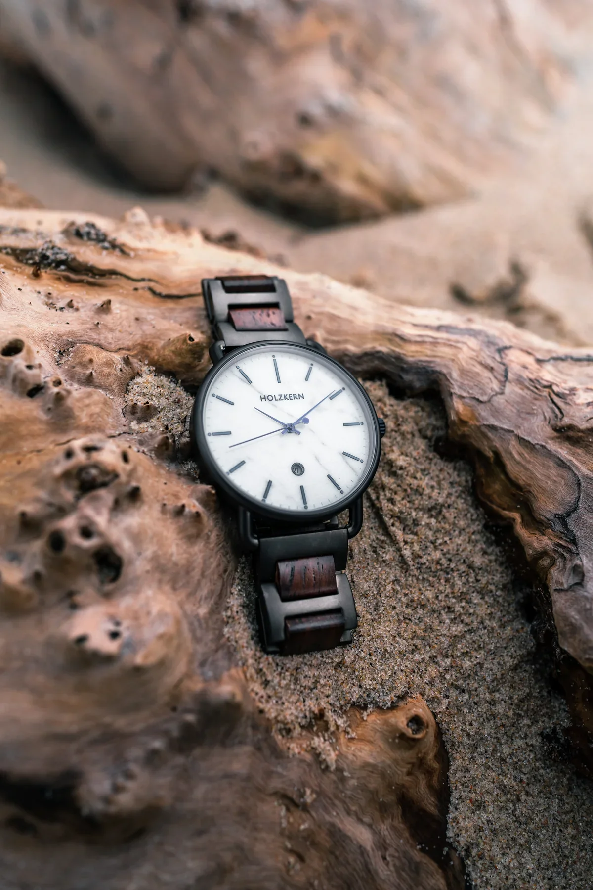 White-dial Holzkern watch on pale driftwood and sand