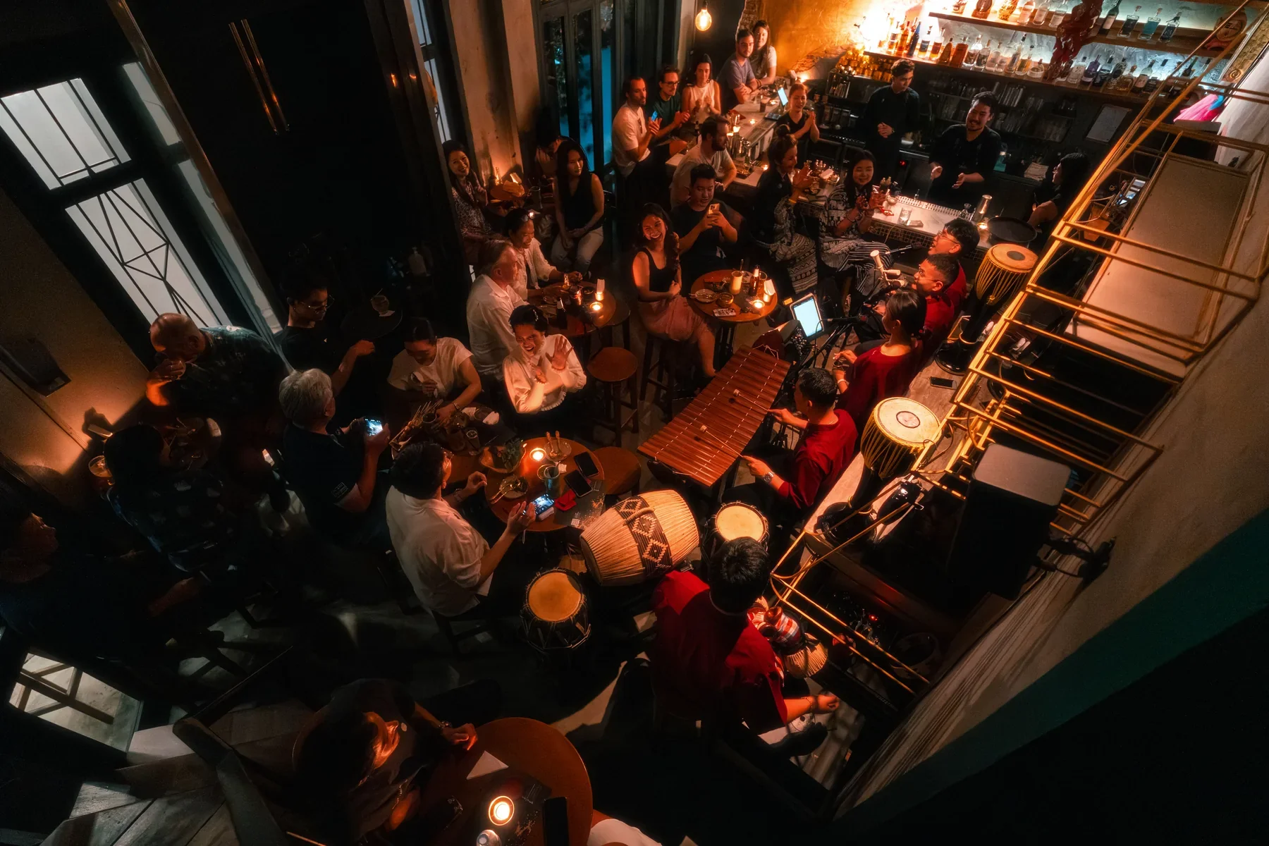 Crowded tables and bar seen from above at TEP BAR