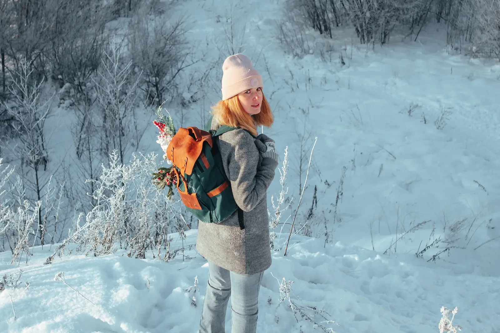 Woman carrying a Wildbags backpack in a snowy landscape