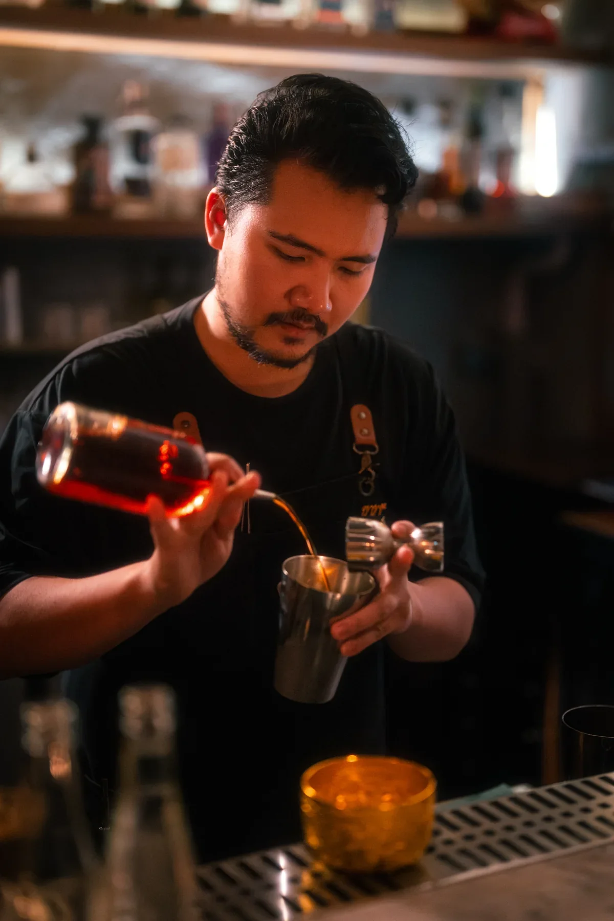 Bartender measuring a drink at TEP BAR