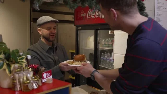 A plate of German food handed across the food counter.