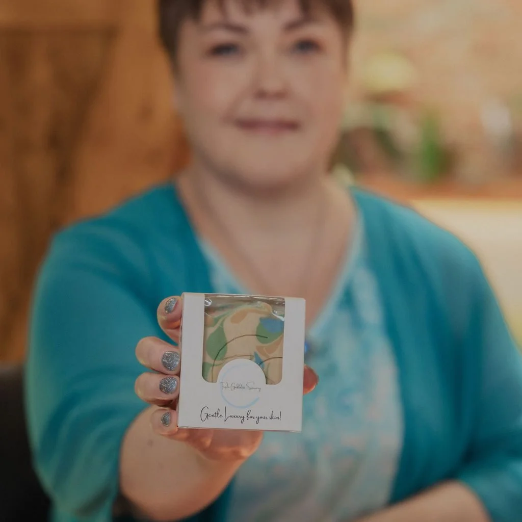 Angela holding out a boxed bar of soap towards the camera
