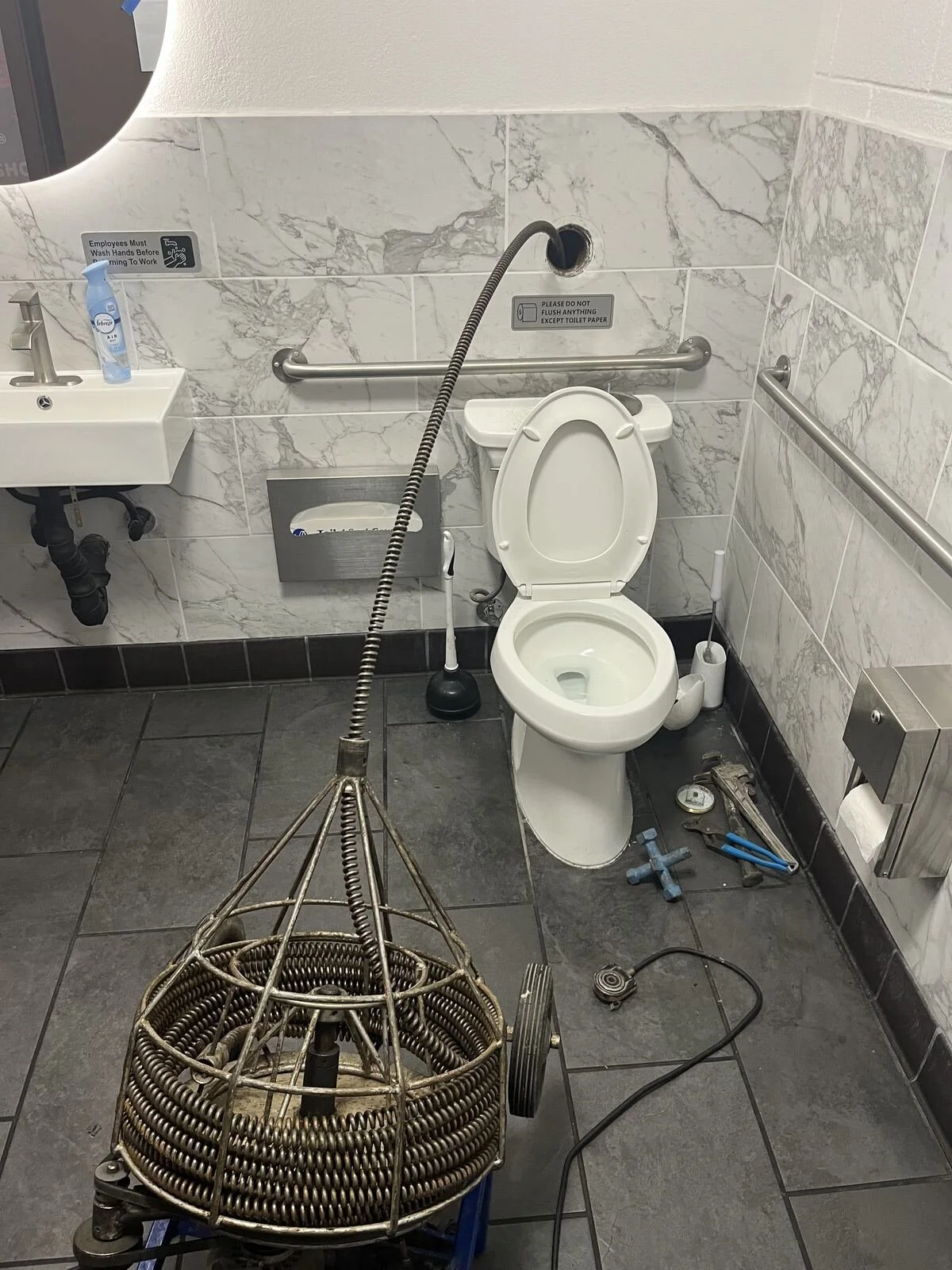 Rod's Plumbing tech clearing a bathroom drain in a Fresno home