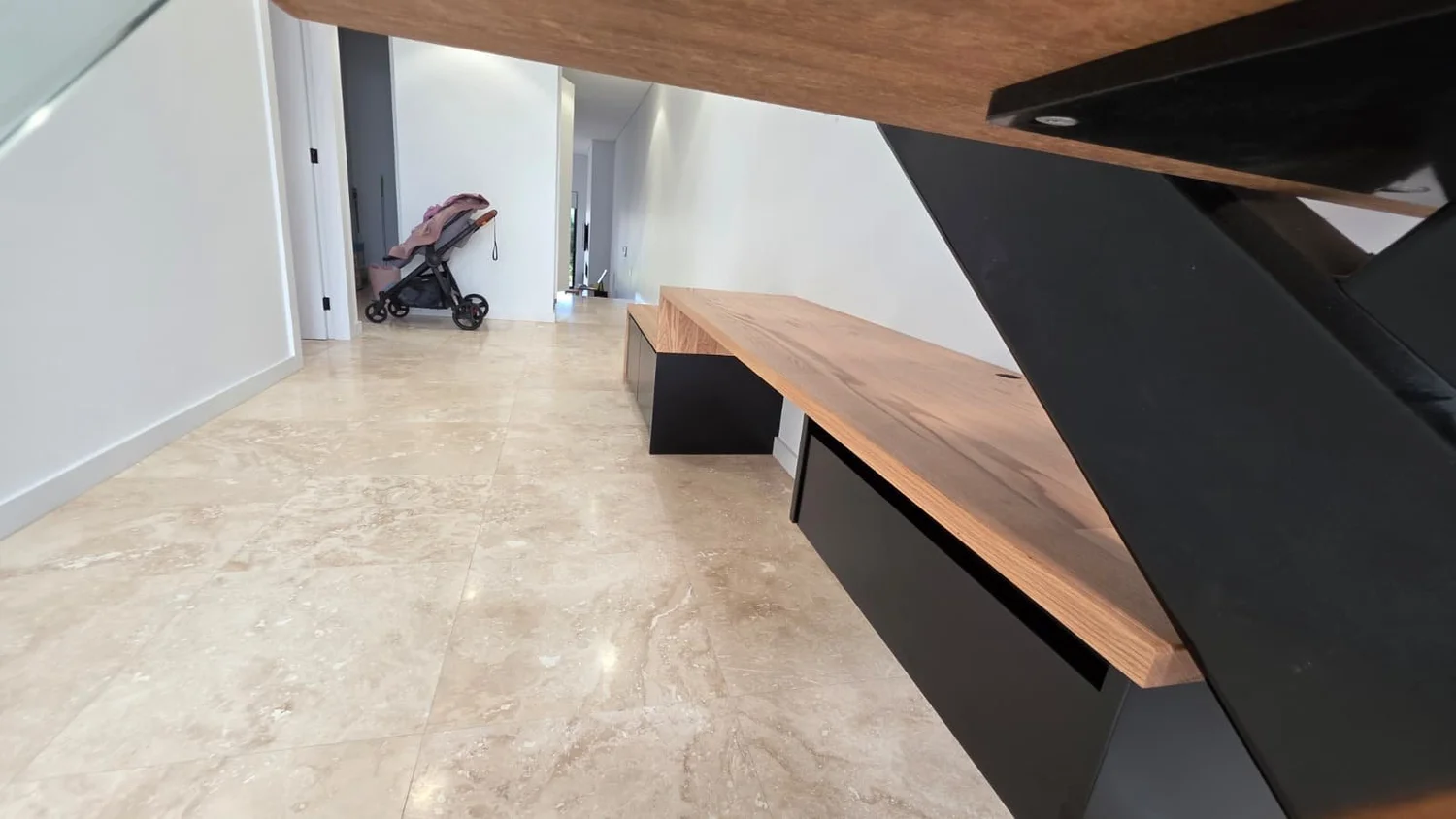 Detail of the oak desktop meeting the black steel stair stringer