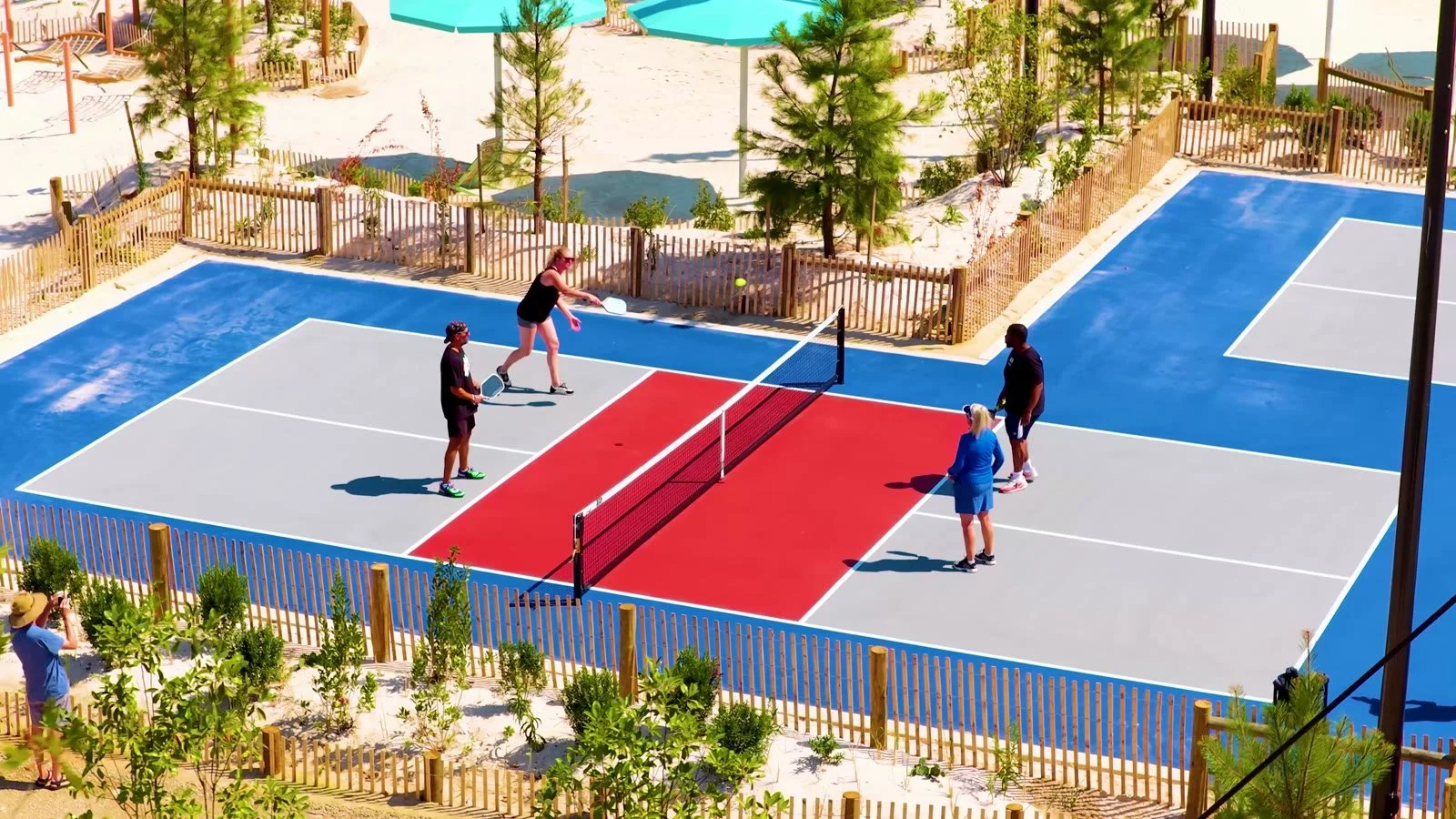 Four people play pickleball on the colorful courts at Rash Field Park in Baltimore.