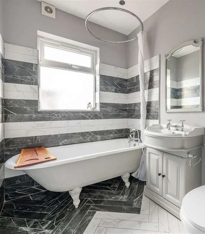 The family bathroom with salvaged roll-top clawfoot bath