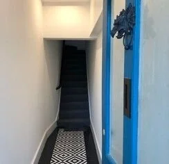 Building entrance after — geometric tile and blue door