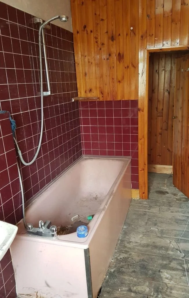 Before: the original bathroom with red tiles and pink bath