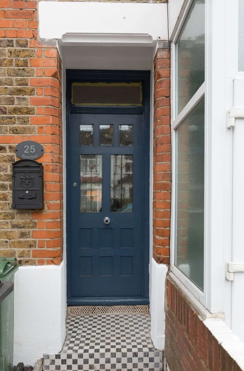 The restored front door and original checkerboard tiled path