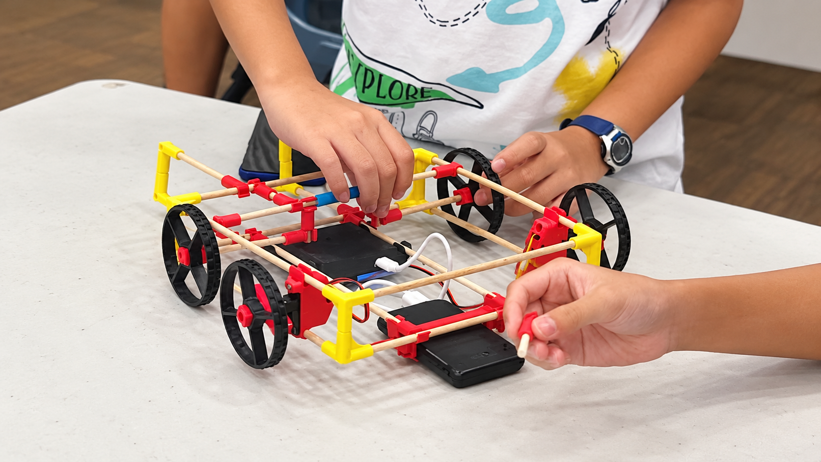 Children taking part in a hands-on STEM and social impact programme using STICK’EM technology