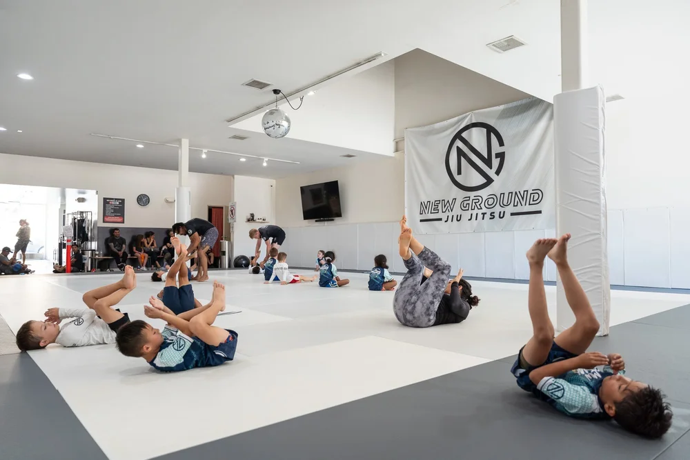 Kids drilling across the mats in a New Ground kids class