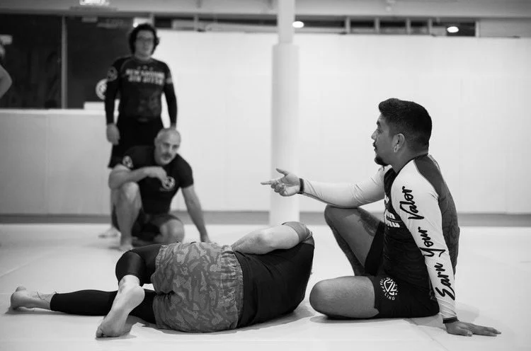 A coach talking a pair of students through a position