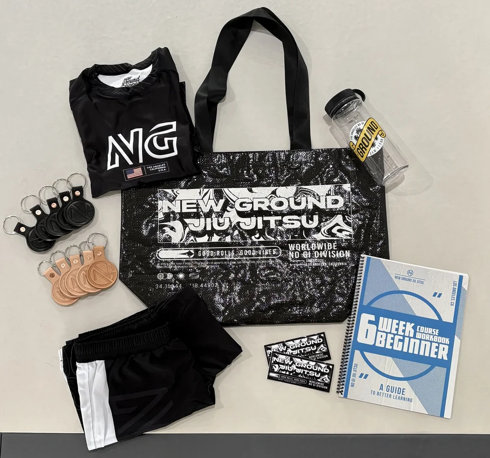 Everything included with the First 30: rashguard, shorts, tote, water bottle and the beginner workbook