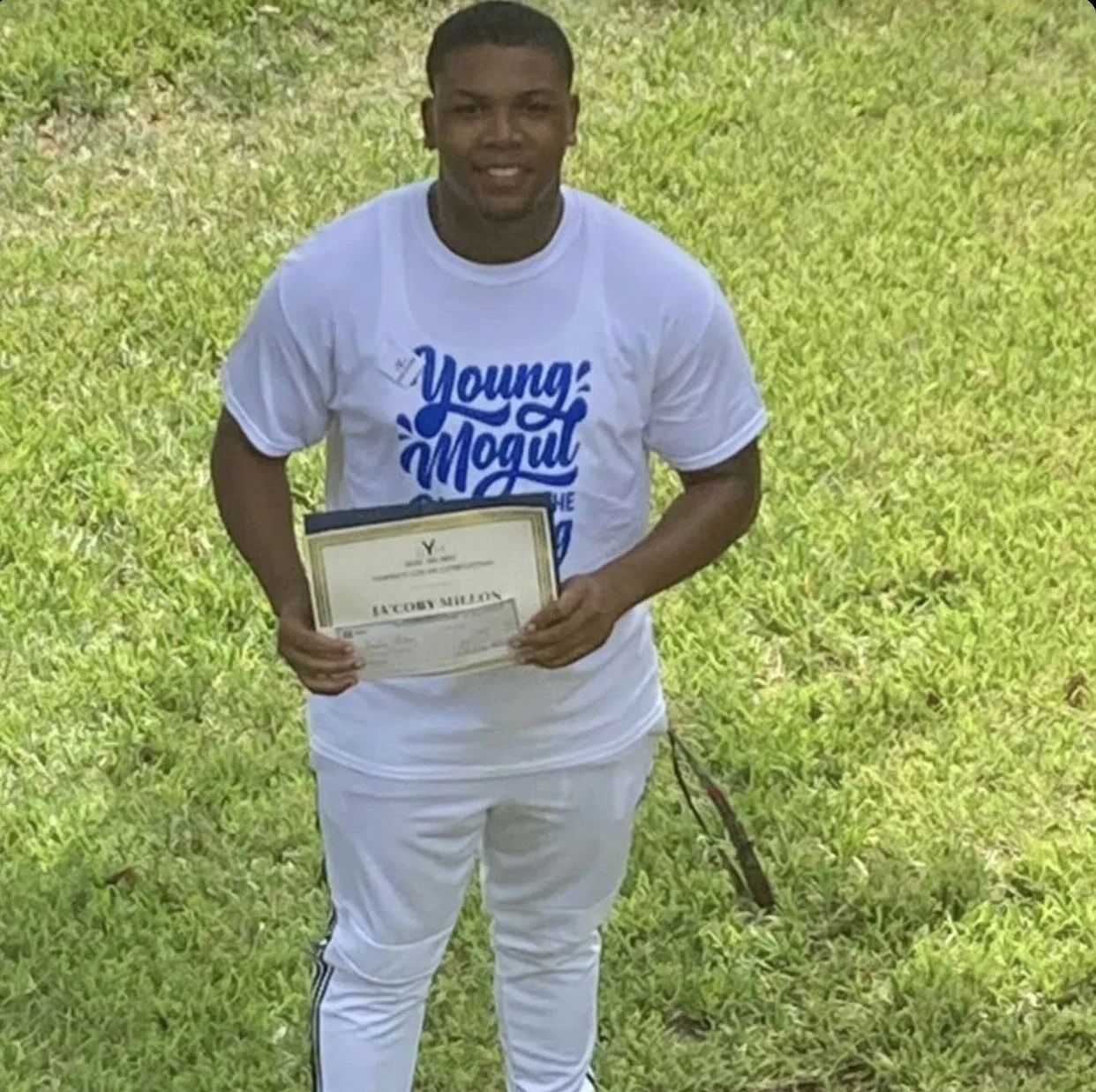 Ja'Coby Millon holding his BYM certificate of completion