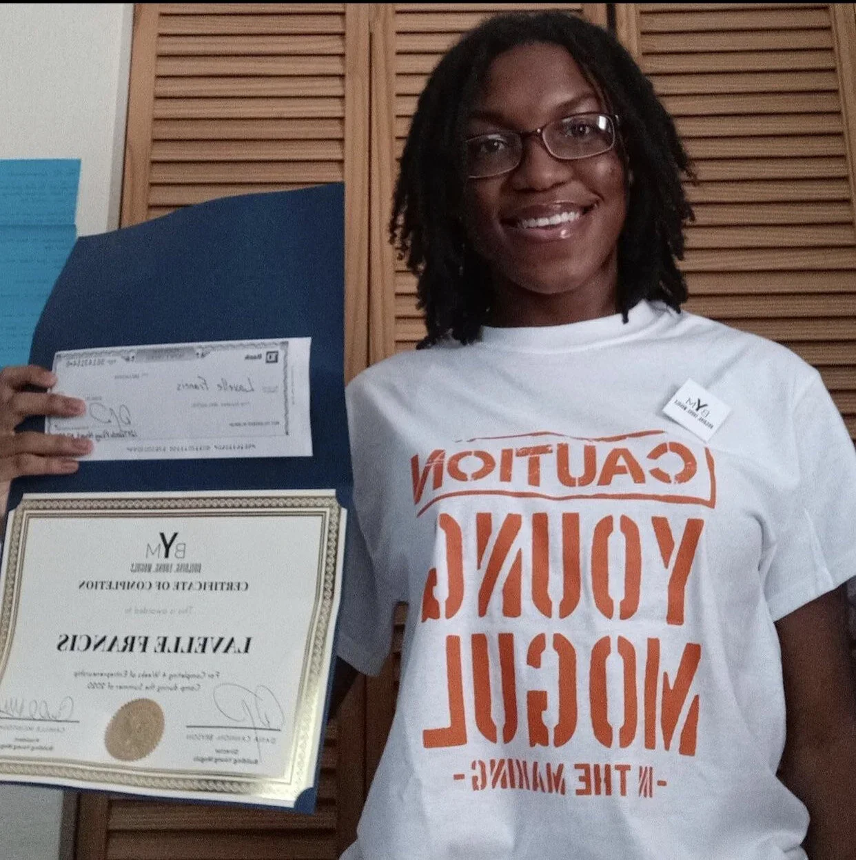 Lavelle Francis holding a BYM certificate of completion