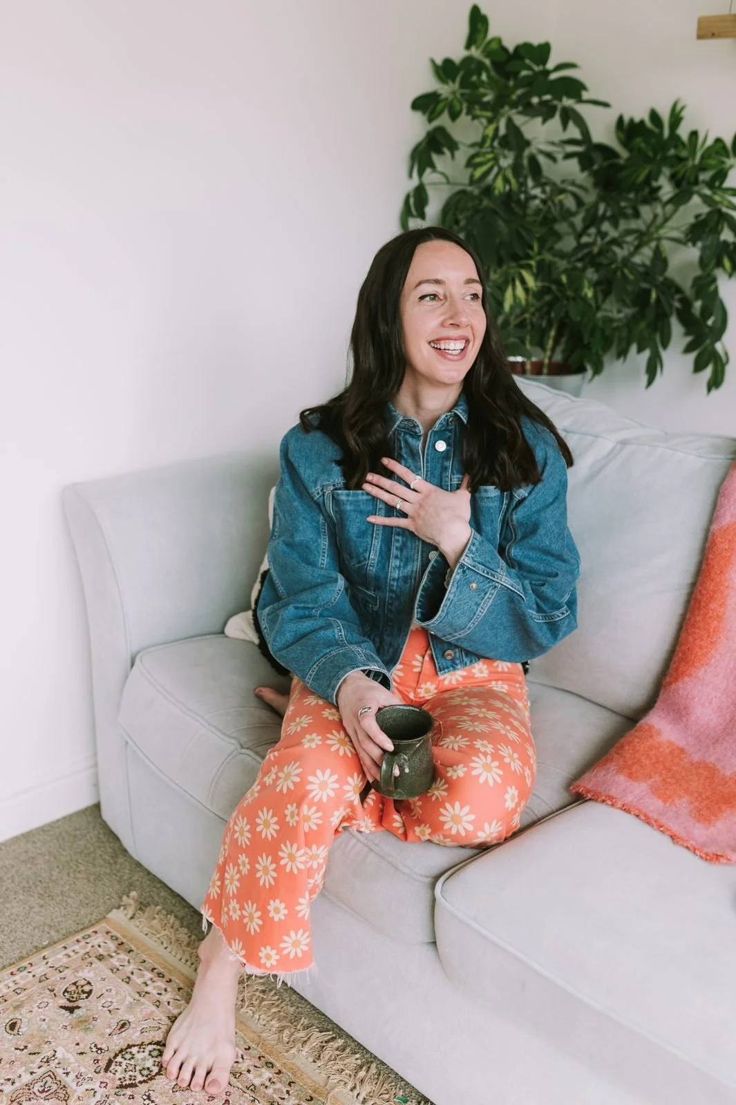 Lauren laughing with her hand on her heart