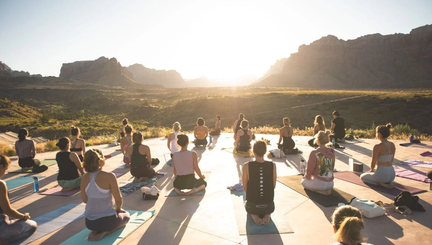 Group sunrise yoga in the mountains