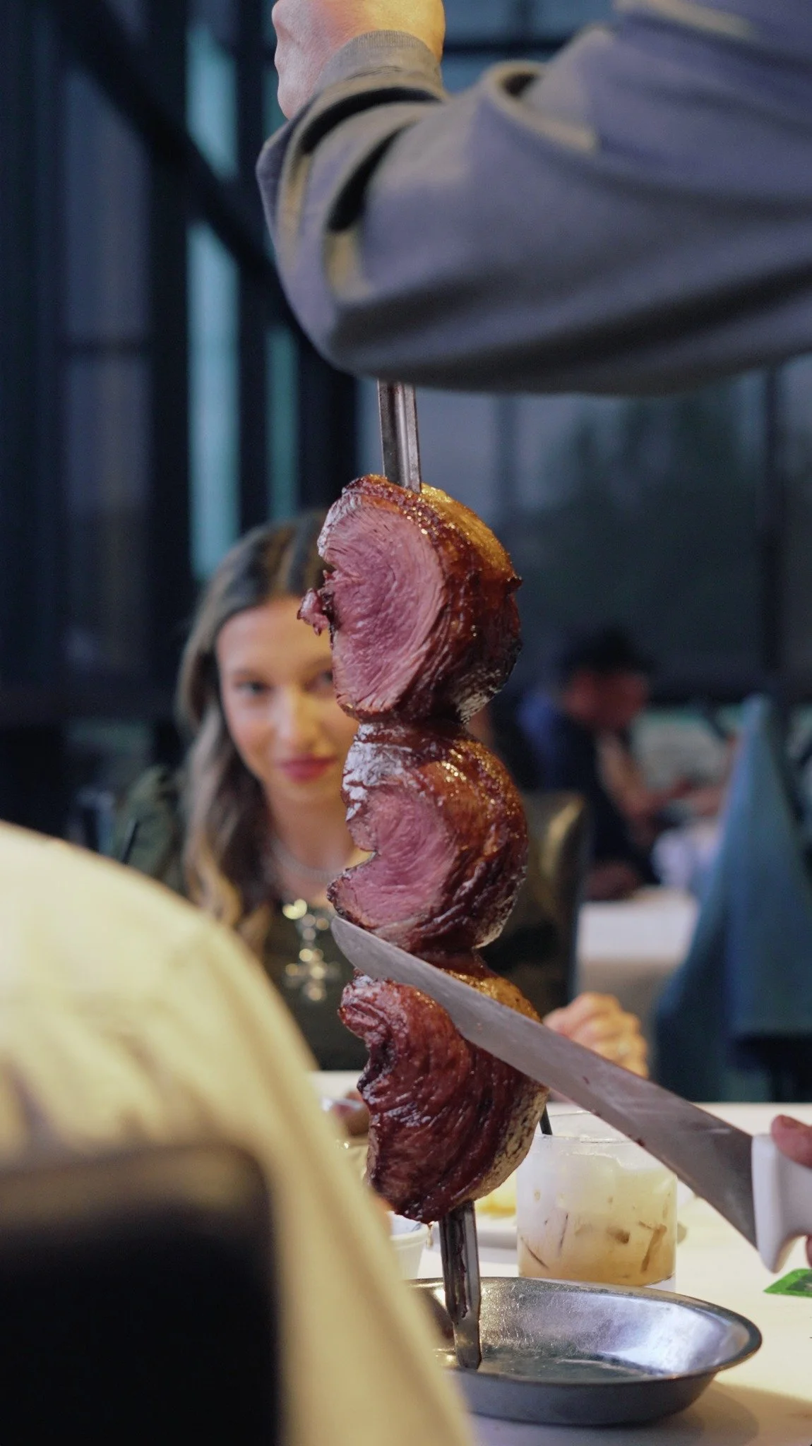 Guests and skewers of fire-roasted meat