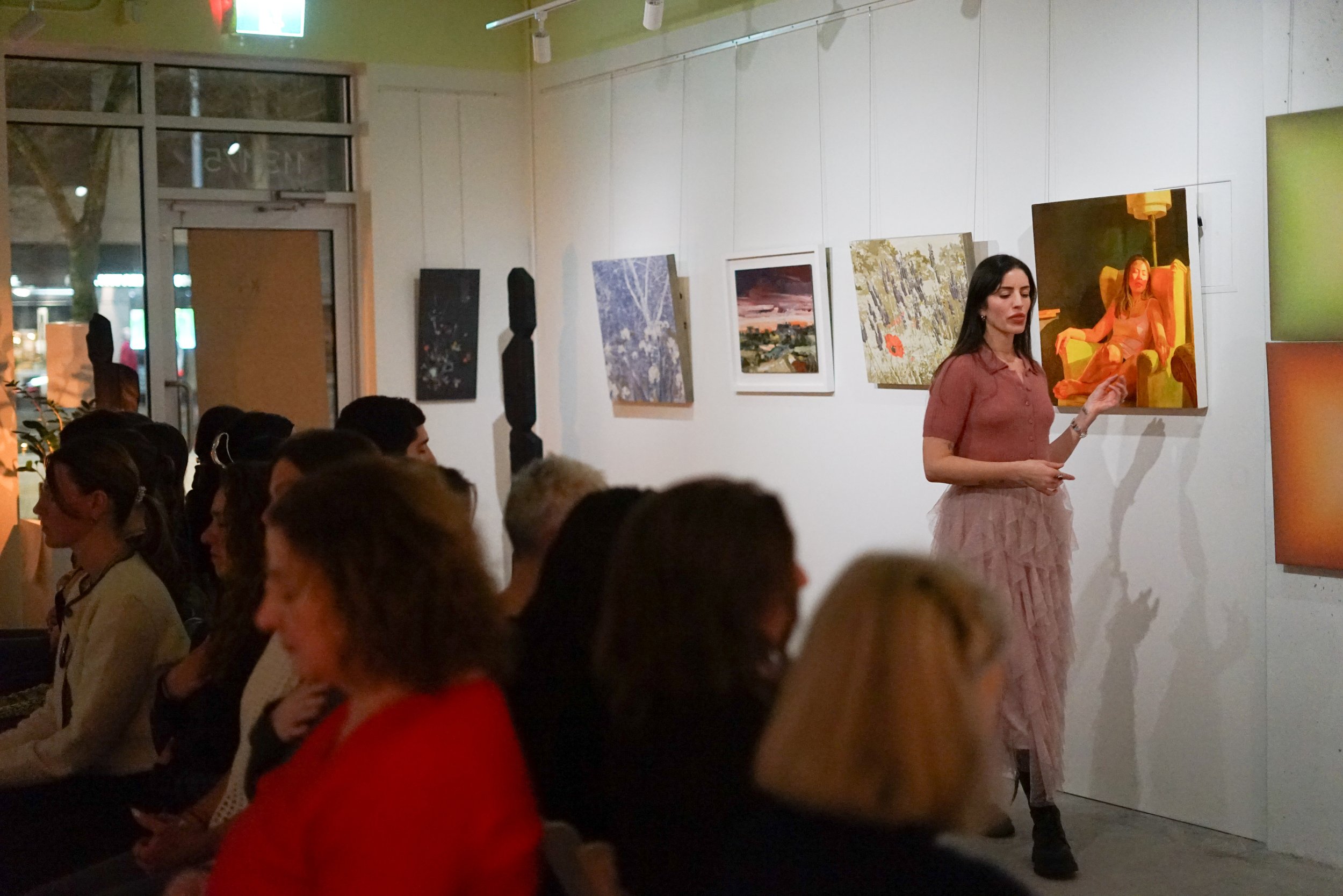 Lisa Littleton leading a live guided meditation at an art gallery