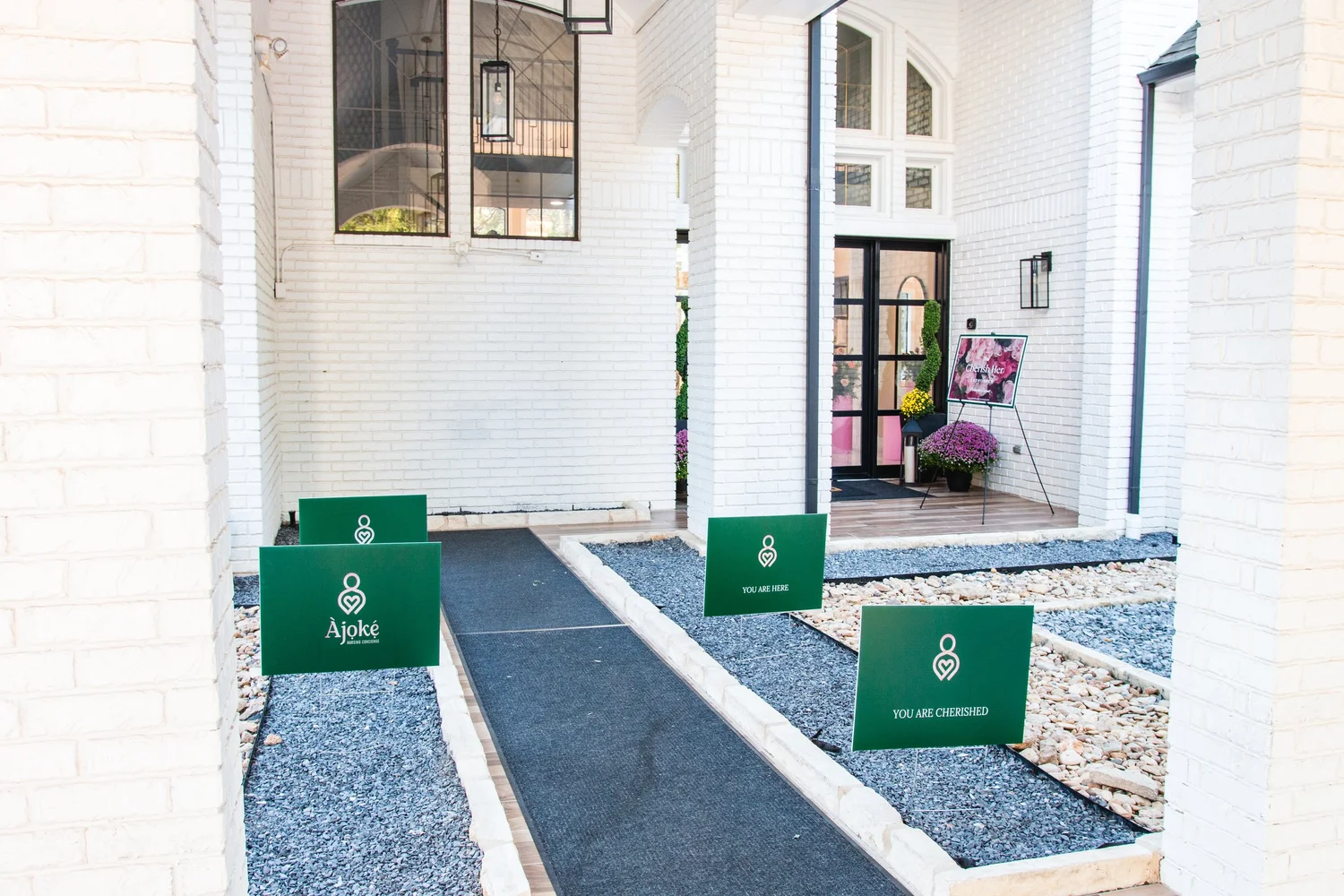 Ajoke and Cherish Her welcome signs line the walkway into the event.