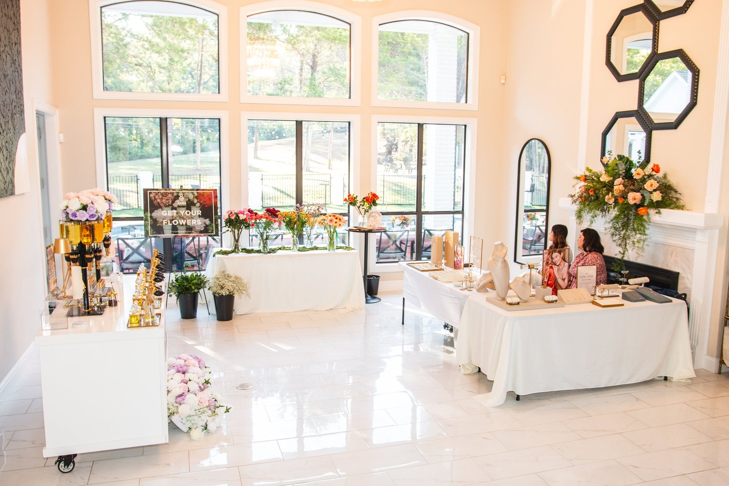 Floral, fragrance, and jewelry stations arranged within the Cherish Her event.