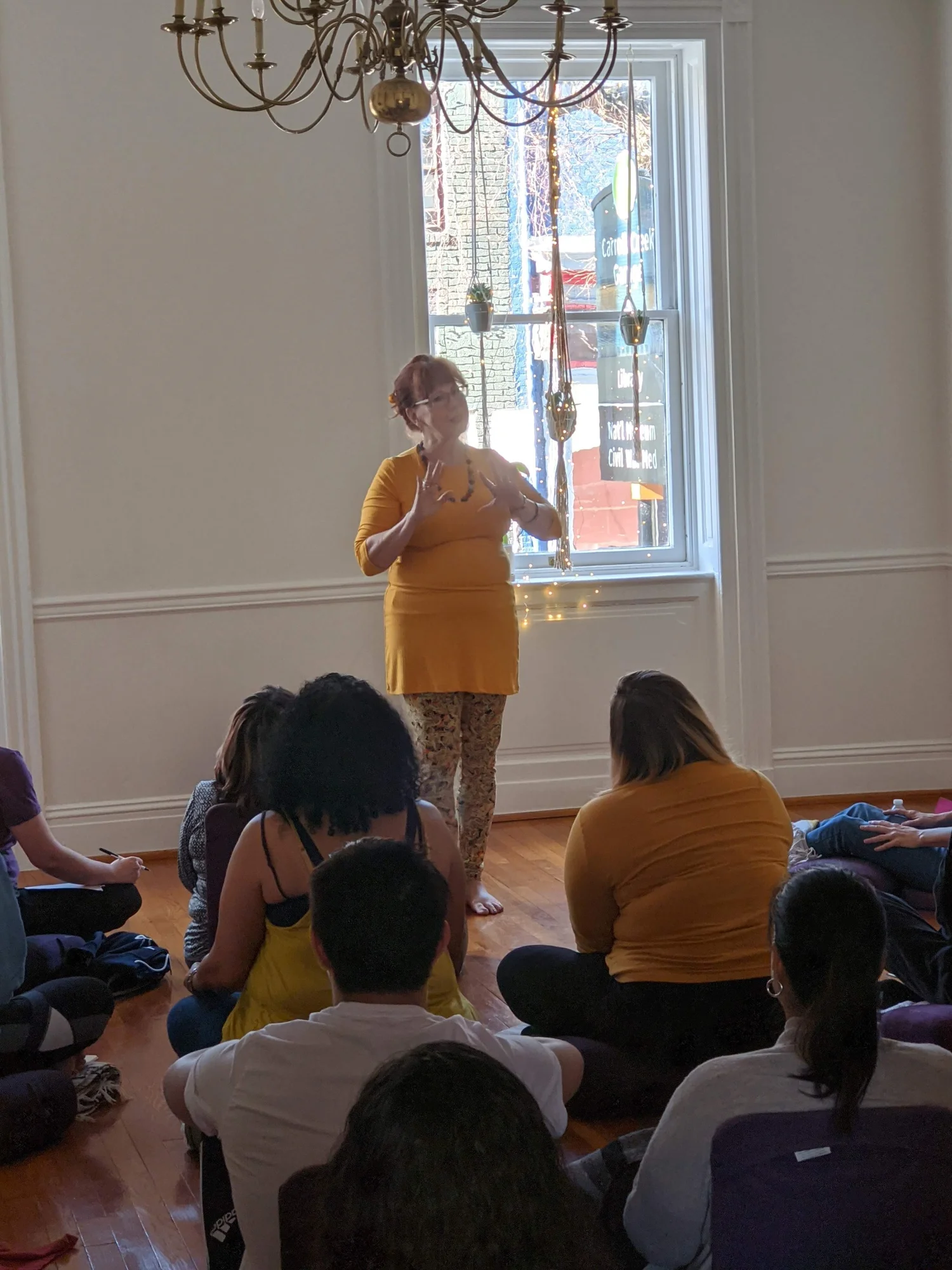Jill speaking to a small group seated in a bright room.