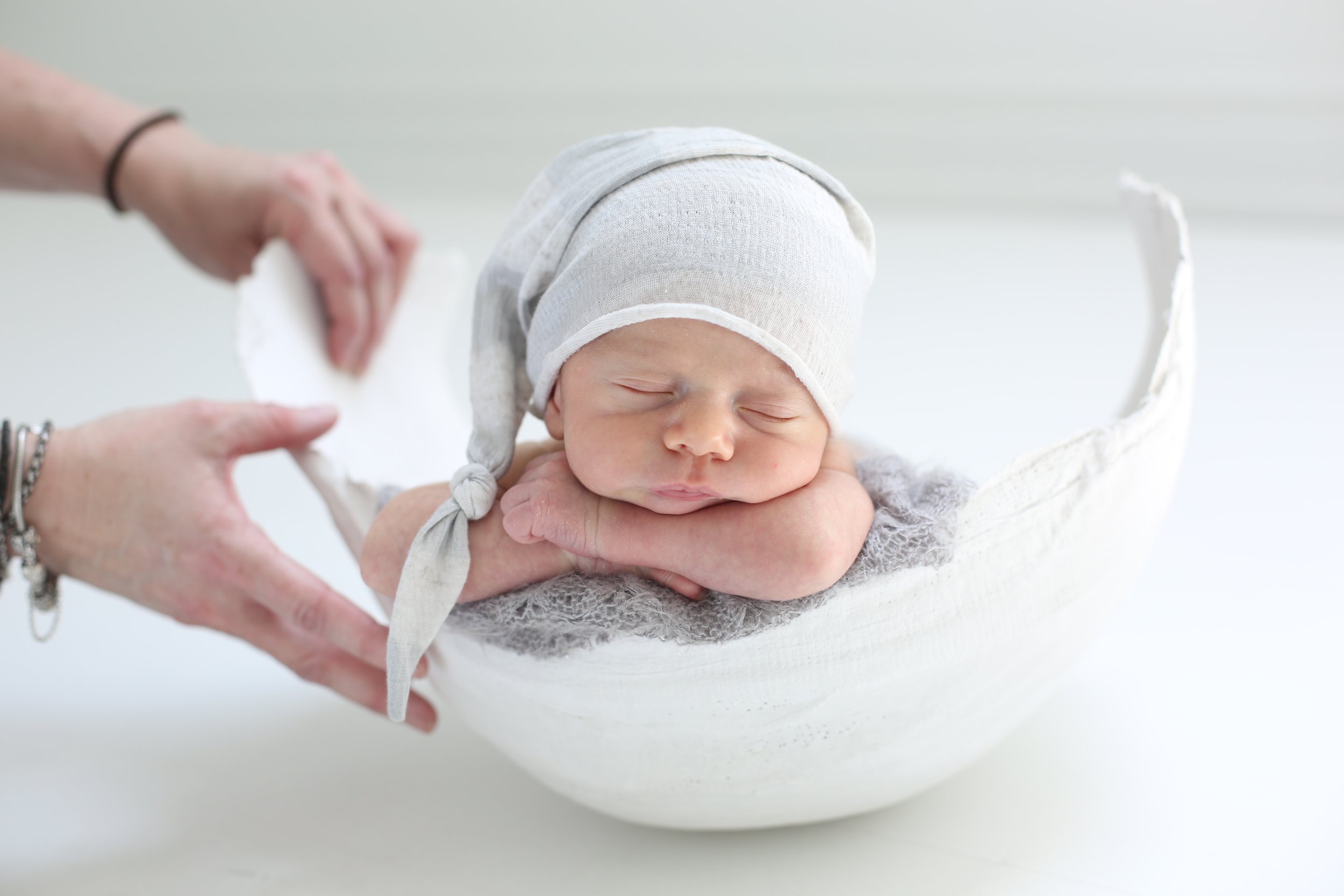Newborn photographed resting inside a finished belly cast