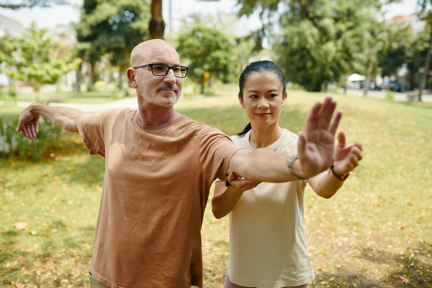 An instructor guiding a small group through a movement outdoors