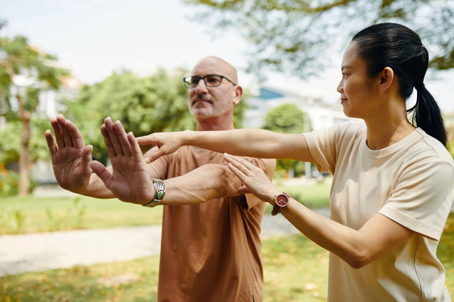 A teacher gently adjusting a student arm position