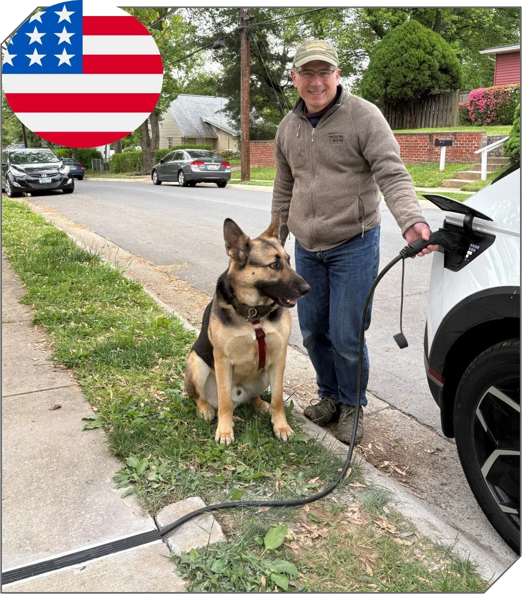 [HERO IMAGE ALT TEXT - Clark and his dog by his car at the curb, cable running through the channel in the sidewalk]