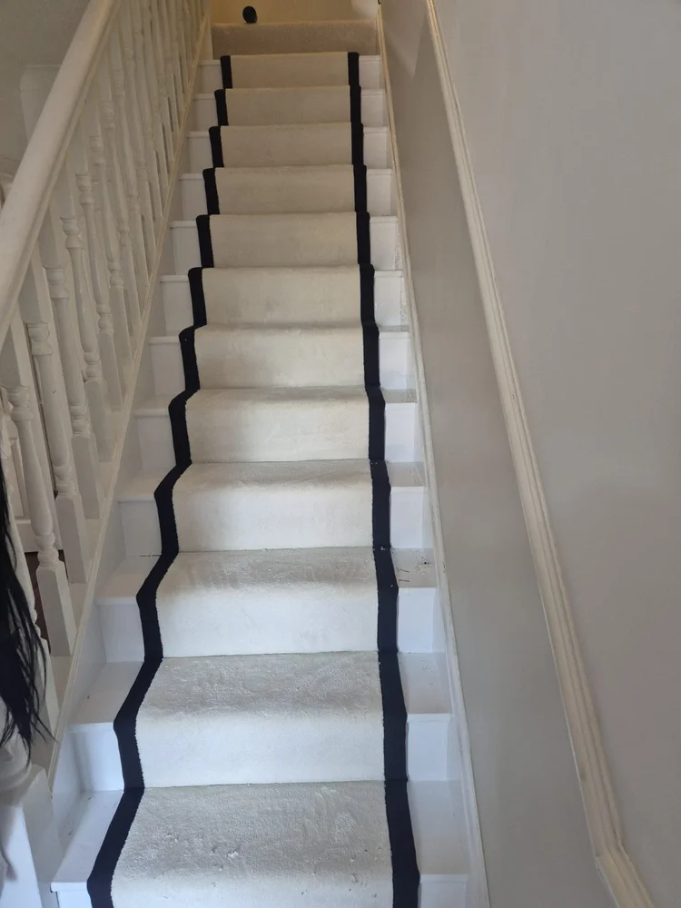 Cream stair runner with a dark border