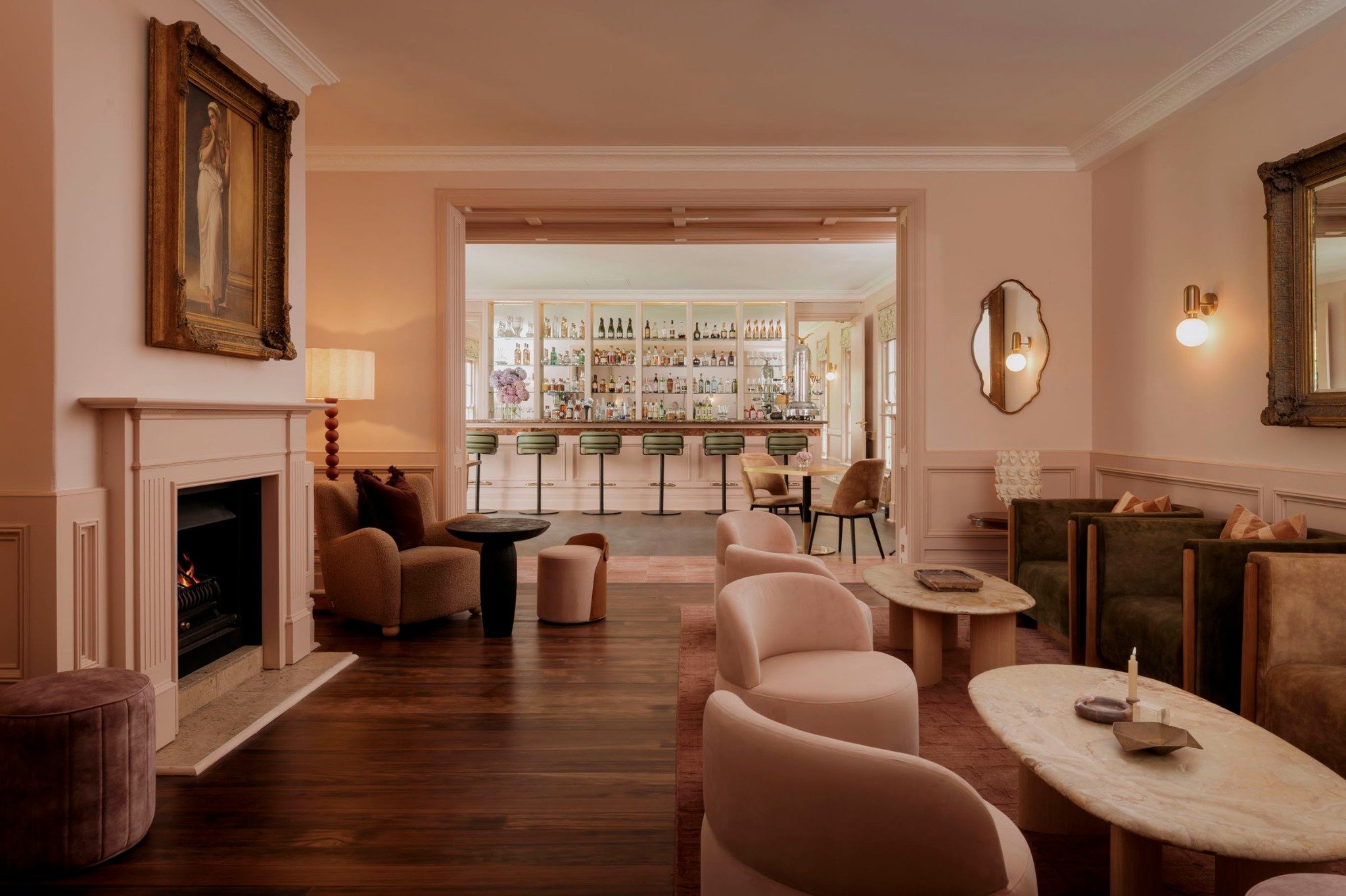 The blush-toned lounge and fireplace at Ardour Milton Park